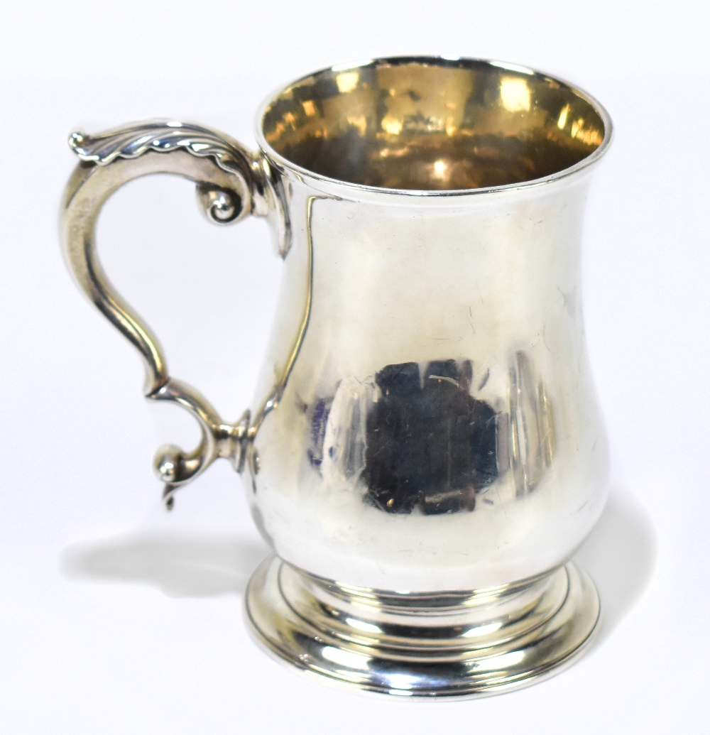 CGMB; a George III hallmarked silver baluster mug with cast scroll handle, London 1773, height 13cm,