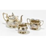 An Edwardian Anglo-Indian white metal three piece tea set, the teapot with finial modelled as a