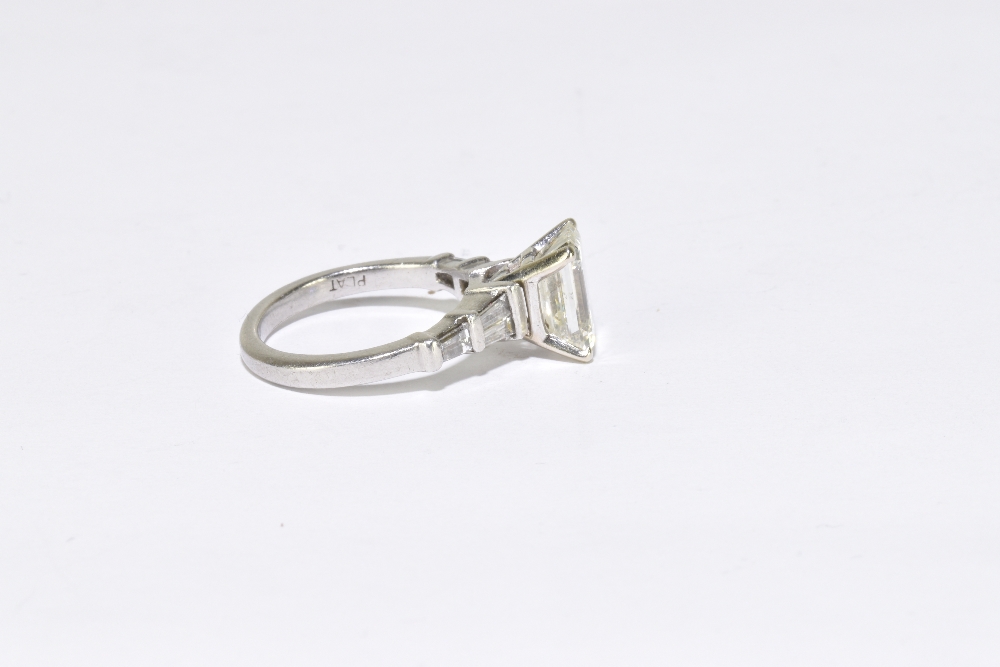 A platinum and diamond solitaire ring, the principal emerald step cut stone, weighing 3.04cts, - Image 3 of 4