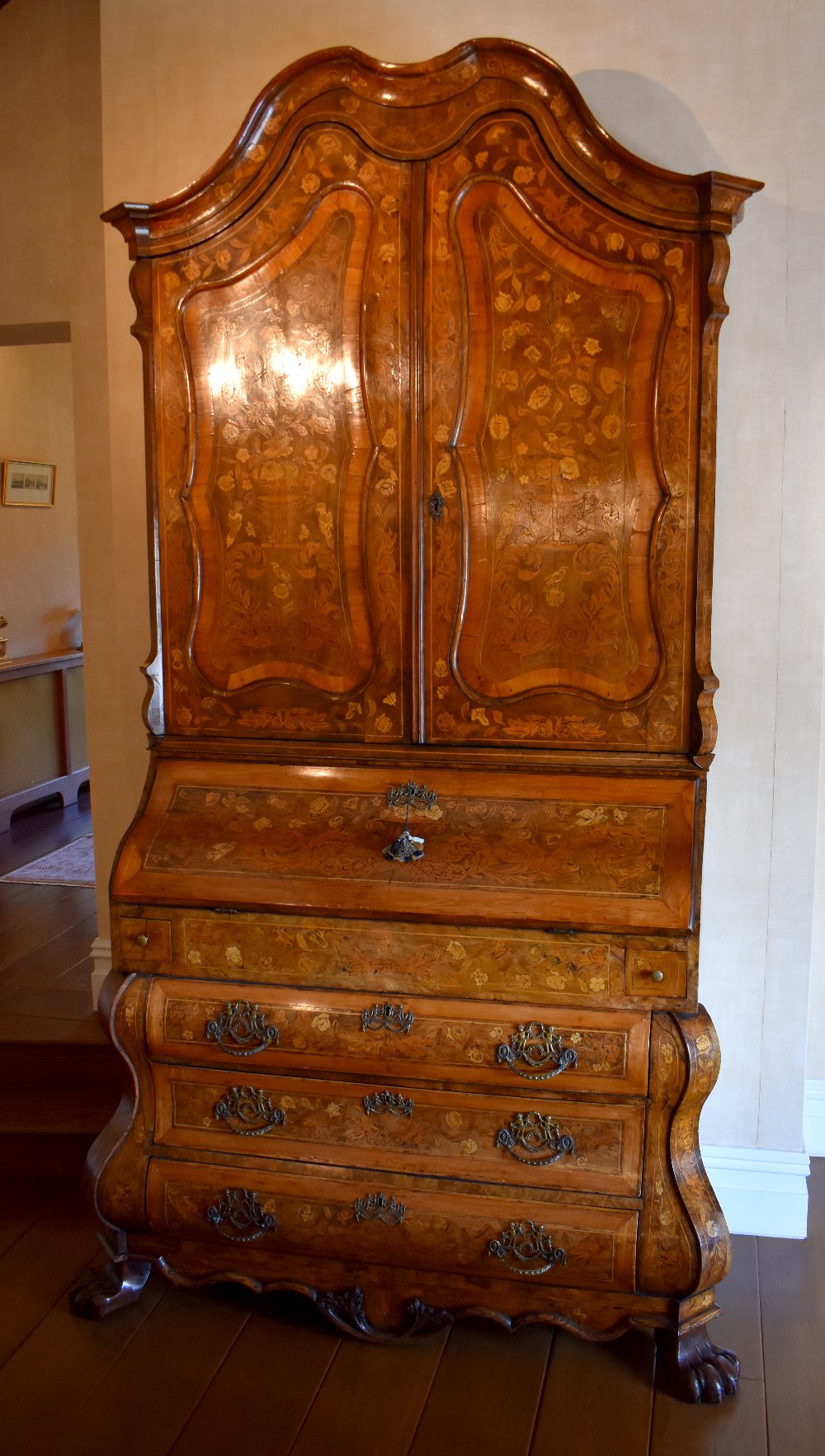 A very large late 18th century Dutch marquetry inlaid bureau bookcase, the shaped cornice above
