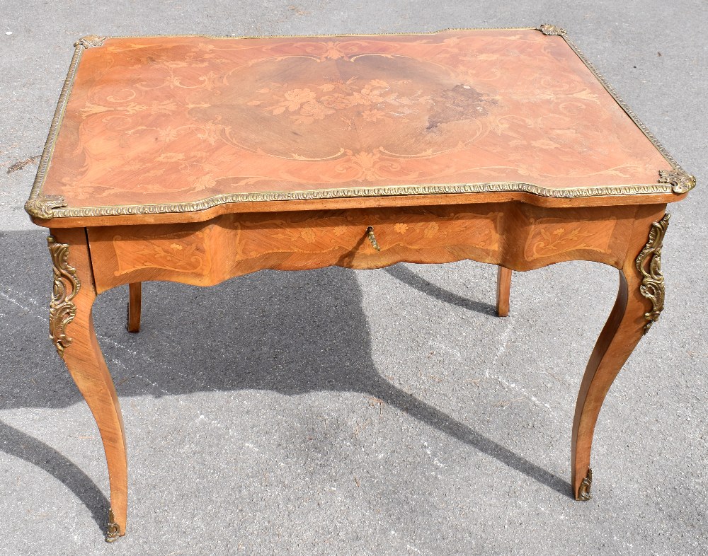 An early 20th century French inlaid kingwood inverted breakfront writing table with gilt metal