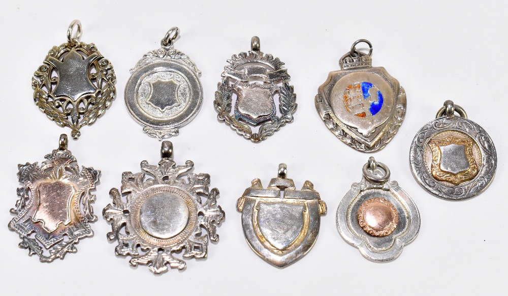 Nine various hallmarked silver fob medallions with vacant panels, one with enamelled detail, all