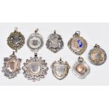 Nine various hallmarked silver fob medallions with vacant panels, one with enamelled detail, all