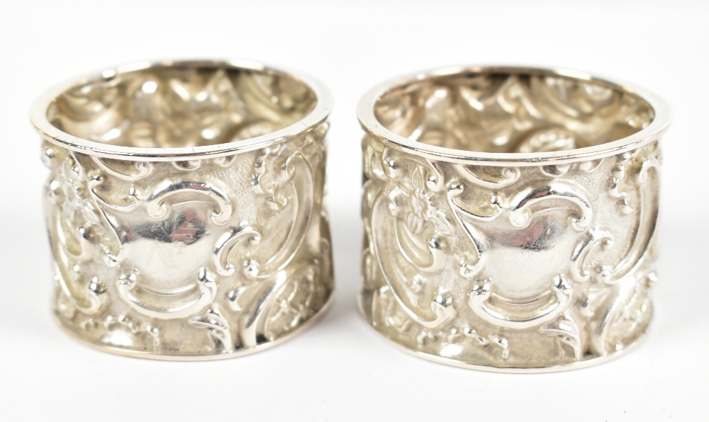 GEORGE NATHAN & RIDLEY HAYES; a pair of Edward VII hallmarked silver napkin rings of circular form