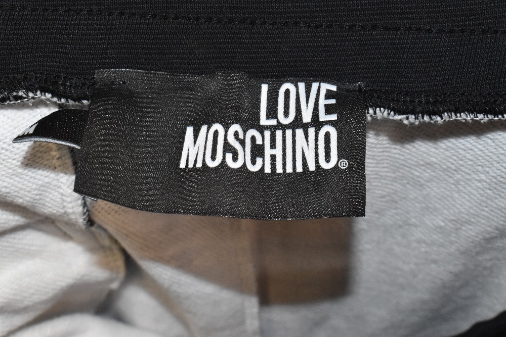 LOVE MOSCHINO; a pair of multi-coloured 100% cotton 'Cassette Tape' print jogging bottoms with two - Image 5 of 5