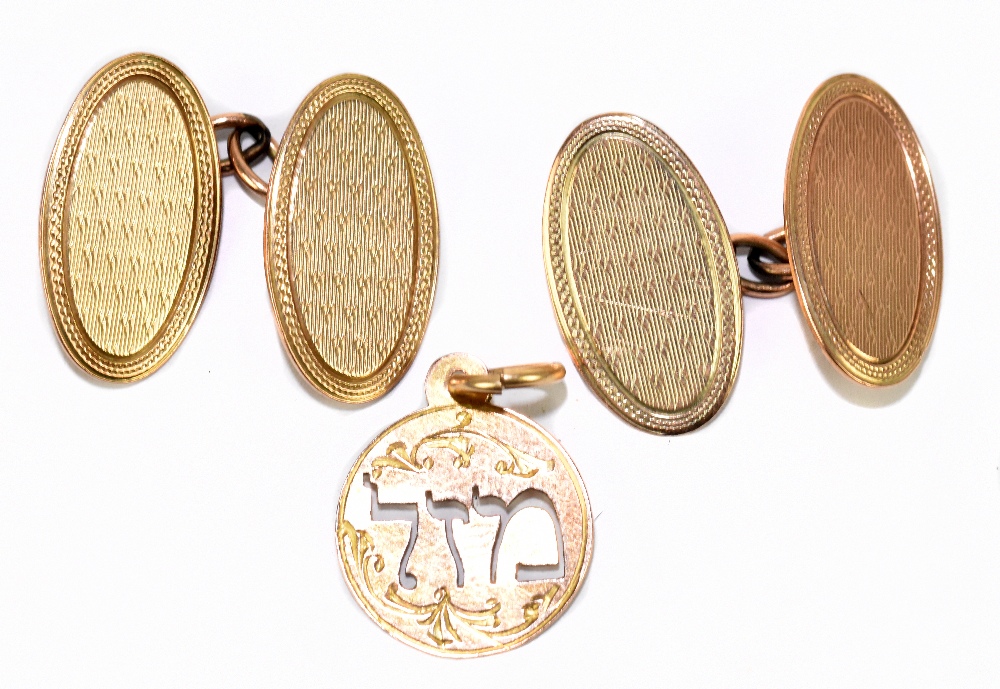 A pair of 9ct yellow gold cufflinks with engine turned detail to the oval platforms, approx 5.5g,