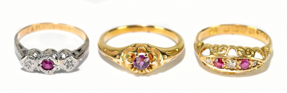 An 18ct yellow gold ruby and diamond five stone half hoop ring, size J, and two yellow metal rings