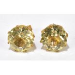 A pair of yellow metal ear studs set with large pale green stones, with 9ct gold butterfly backs,