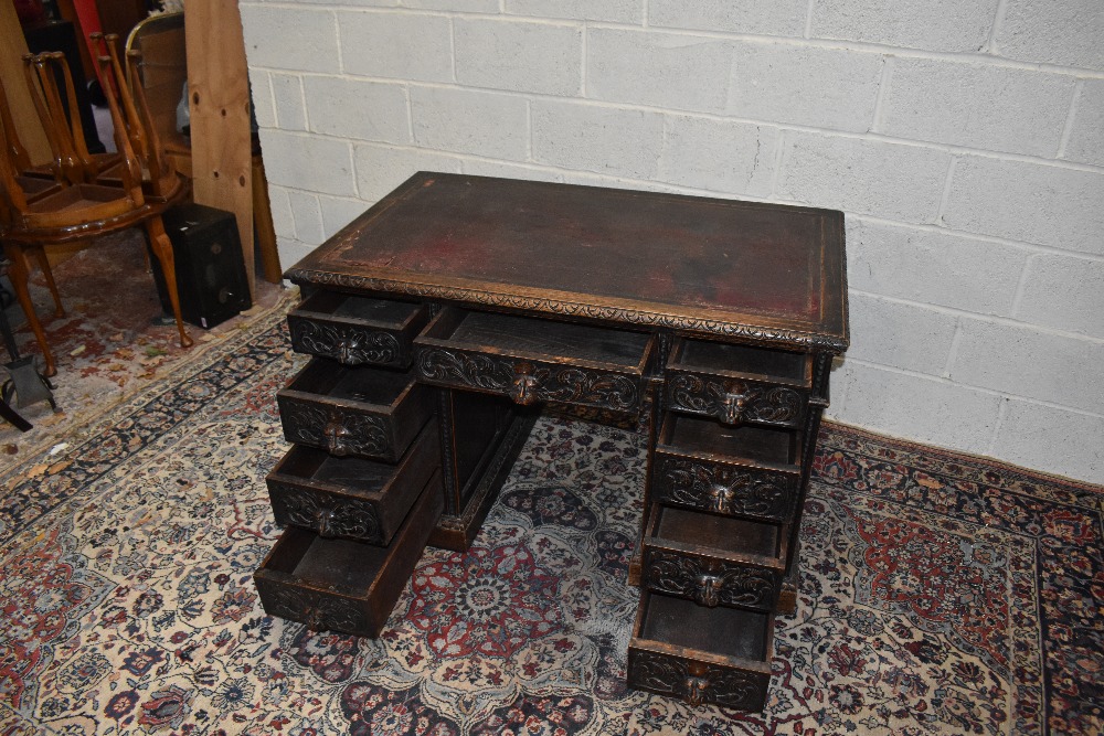 A Victorian carved oak nine drawer pedestal desk, 121.5 x 74cm.Additional InformationLeather top - Image 3 of 3