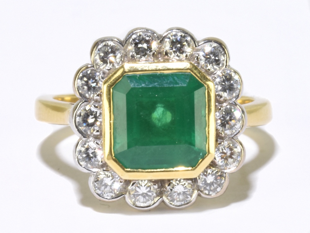 An 18ct yellow gold emerald and diamond ring, the central square cut emerald measuring approx 8mm in
