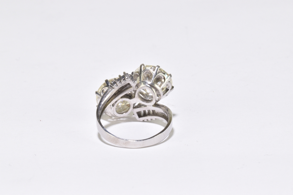 A white metal diamond crossover ring with twin round brilliant cut stones weighing 4.20ct and 3. - Image 5 of 5