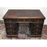 A Victorian carved oak nine drawer pedestal desk, 121.5 x 74cm.Additional InformationLeather top
