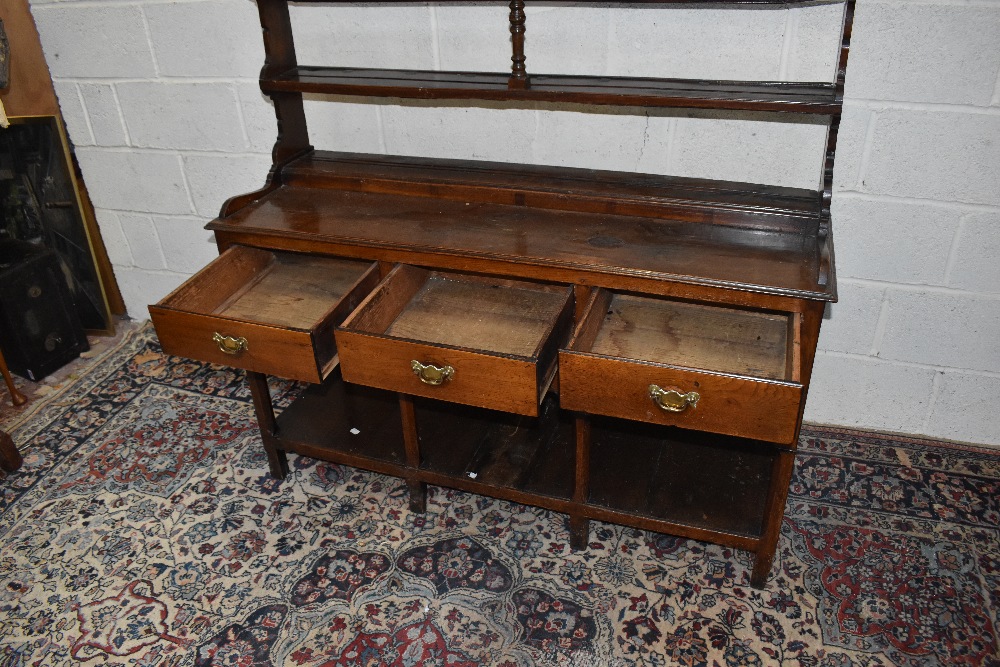 An 18th century oak dresser, with open plate rack back having central turned spindles and three - Image 2 of 3