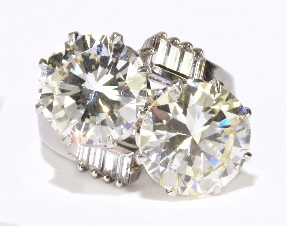 A white metal diamond crossover ring with twin round brilliant cut stones weighing 4.20ct and 3. - Image 2 of 5