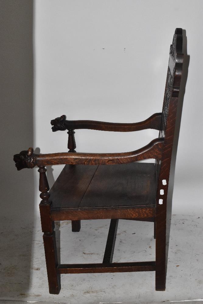 A Victorian carved oak open arm elbow chair with iron mask terminals and square supports. - Image 3 of 4