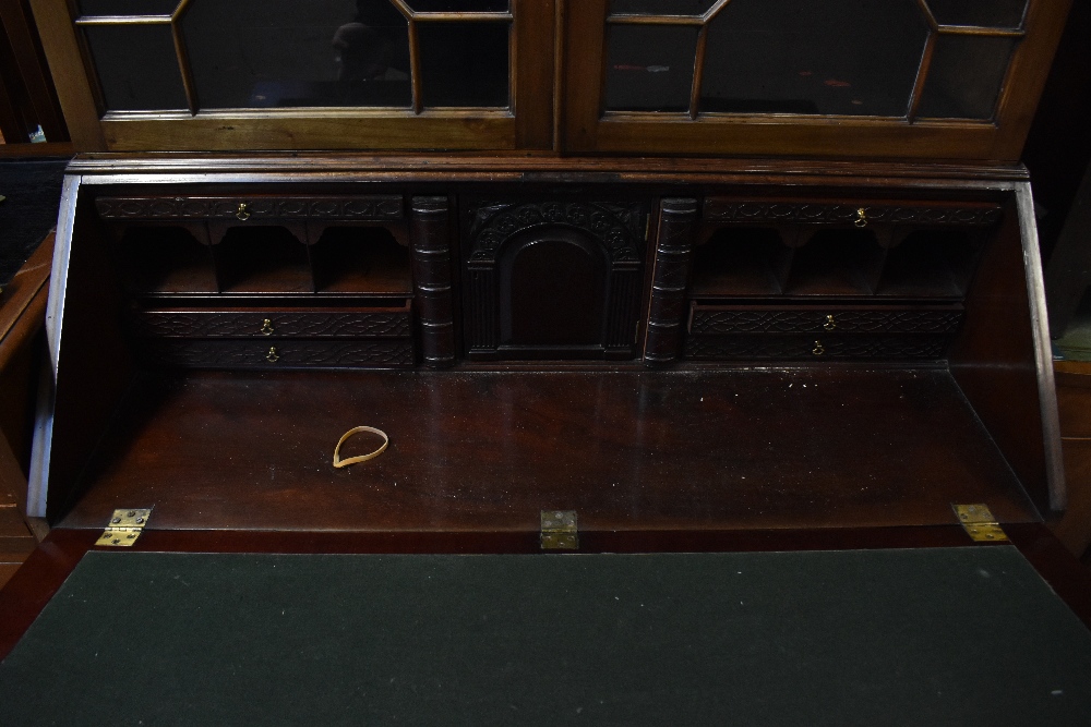 A Georgian mahogany bureau bookcase, the moulded cornice with blind fret decoration above the pair - Image 2 of 2