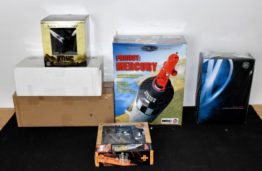 A collection of model kits and figures including official movie merchandise Kong Bursts Through, MRC