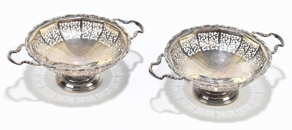 WI BROADWAY & CO; a pair of Edward VII hallmarked silver twin handled pedestal bonbon dishes with