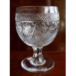 A large 19th century cut glass goblet with band of hobnail detail above wrythen decorated bowl and