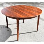 A Danish rosewood extending dining table, with two spare leaves, on tapered legs, height 72cm, width
