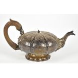 WILLIAM EATON; a George IV hallmarked silver foliate engraved melon shaped teapot, with wooden