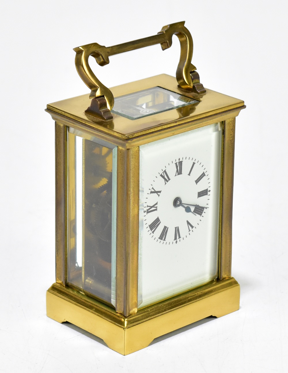 A brass cased carriage clock with rectangular white enamel dial set with Roman numerals, height