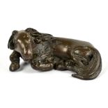 An 18th century Chinese bronze scroll weight modelled as a recumbent ram, length 6.5cm.