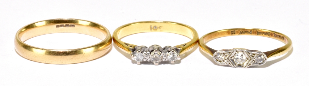 A 9ct yellow gold wedding band, size O 1/2, approx 2.3g, and two 18ct yellow gold three stone