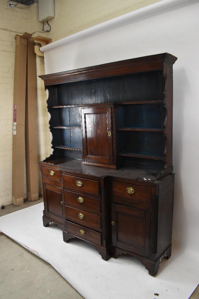 A late 18th/early 19th century oak breakfront dresser, the boarded back with three fixed shelves and - Image 4 of 4