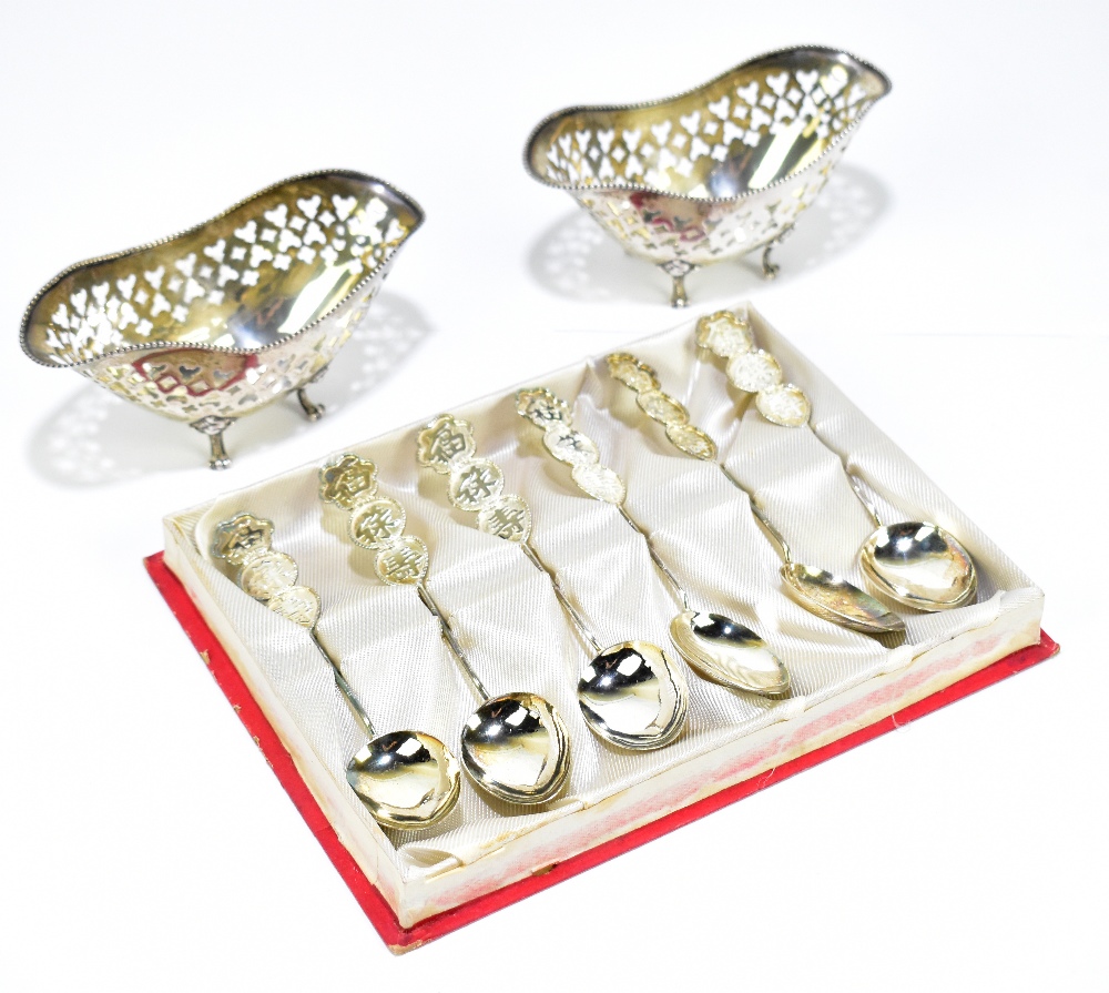 A pair of sterling silver bonbon dishes of oval form with cast beaded rims and pierced decoration to