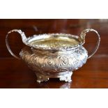 GEORGE HUNTER II; a George IV hallmarked silver and embossed twin handled sugar bowl with traces