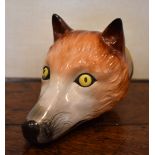 A 19th century Pratt type fox head stirrup cup with painted detail and inscribed 'Tallyo', unmarked,