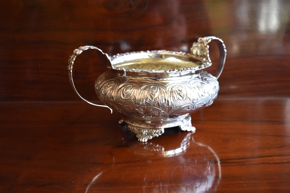 GEORGE HUNTER II; a George IV hallmarked silver and embossed twin handled sugar bowl with traces - Image 2 of 4