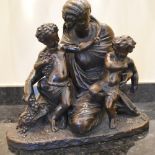 A late 19th century French bronze figure group of a Classical female with two putti, one holding