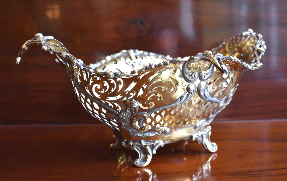 ELKINGTON & CO; a large Edwardian silver gilt pierced bowl with embossed and chased detail