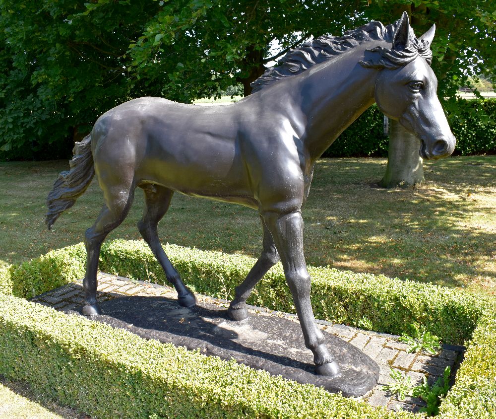 A contemporary bronze life size model of a colt horse standing four square and on integral base,