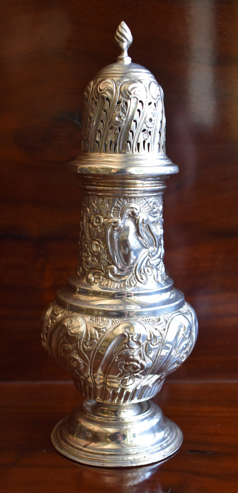 NATHAN & HAYES; an Edwardian hallmarked silver sugar caster of baluster form, with embossed