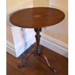 An early 19th century mahogany occasional table, the oval inlaid top centred with a shell patera