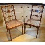 A pair of Edwardian painted satinwood bedroom chairs, each with turned top rail above two horizontal