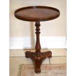 A William IV rosewood occasional table, the circular top with raised gallery above baluster