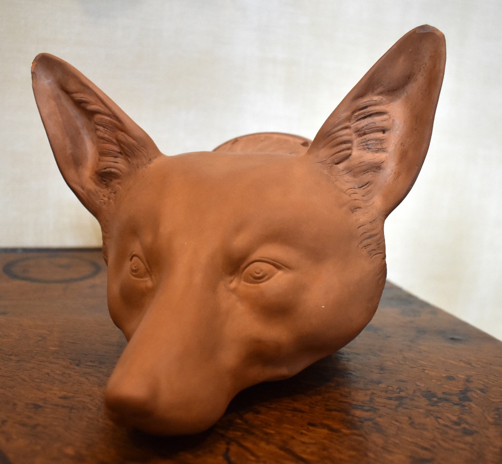 A late Victorian large terracotta fox head stirrup cup, unmarked, length 19cm. Provenance: The