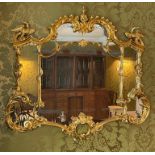 A circa 1900 Chippendale Revival gilt framed Chinoiserie wall mirror with shaped plate, centred with