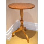 A painted satinwood circular occasional table, the top decorated with three floral sprays above a