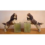 A pair of early 20th century cold painted bronze and green onyx bookends modelled as spaniels,