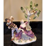 An early 19th century Meissen porcelain figure group of Harlequin and Columbine after the original