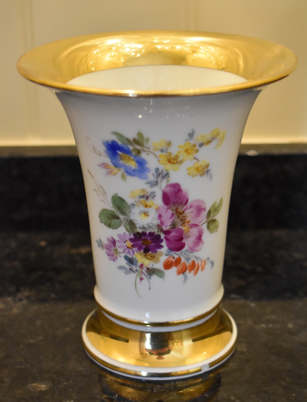 A late 20th century Meissen trumpet vase painted with floral sprays and broad gilt bands, height