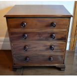 An early 19th century mahogany boxwood strung chest of four long graduated drawers, raised on ogee