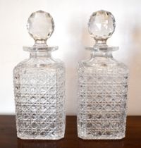 A pair of hobnail cut glass decanters with globular facet cut stoppers, height 25.5cm (2).