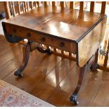 A Regency rosewood and line inlaid sofa table, the rectangular top with twin flaps above two