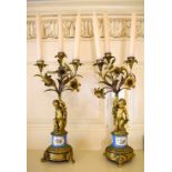 A pair of late 19th century French porcelain and gilt metal mounted three light candelabra, each
